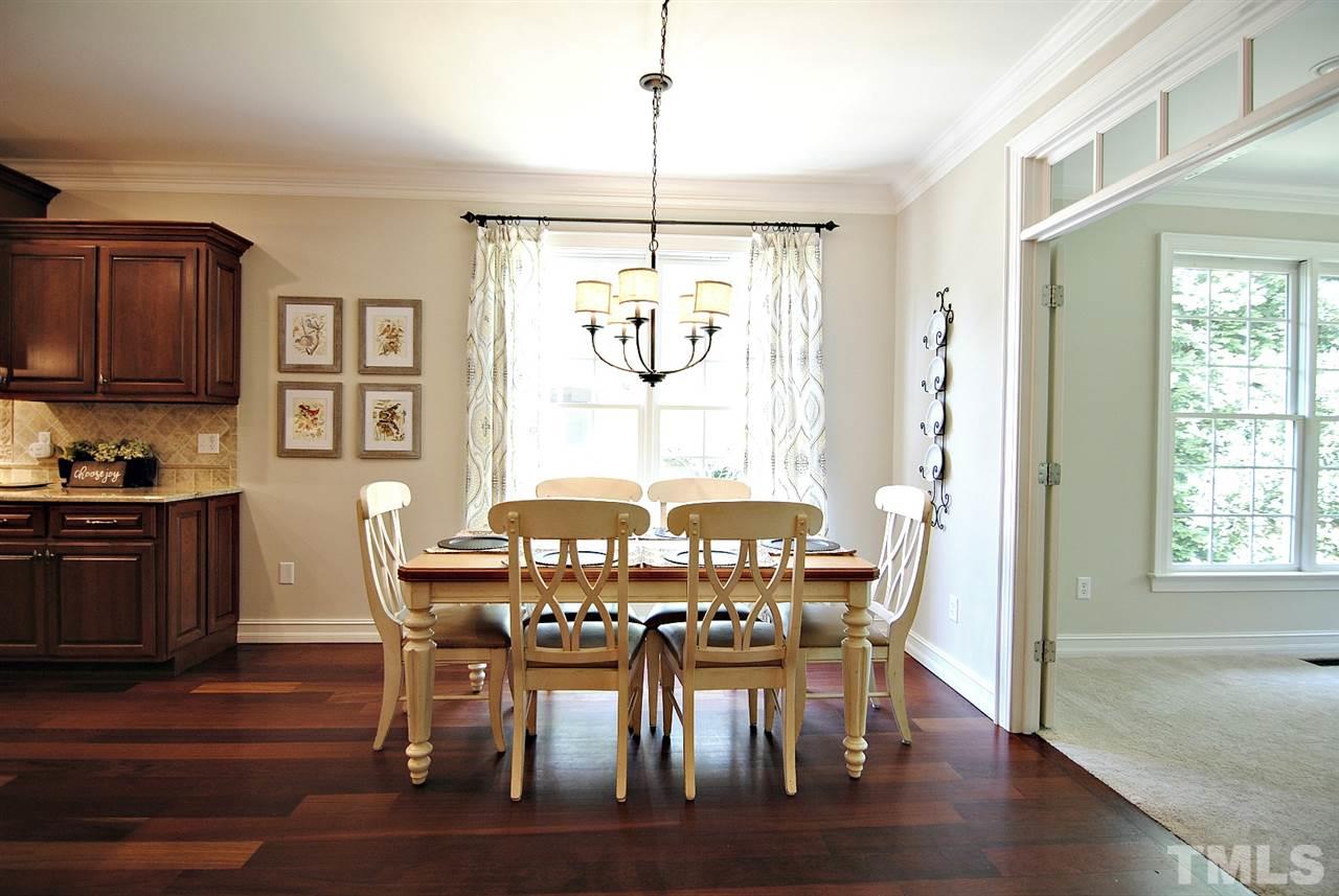3400 Harden Road Raleigh, NC 27607 - Photo 11 of 25 a view of a dining room with furniture window and wooden floor
