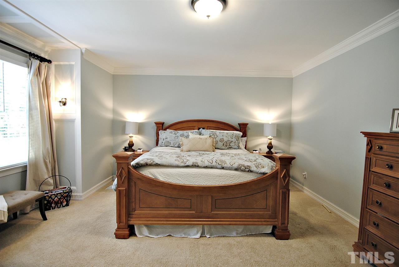 3400 Harden Road Raleigh, NC 27607 - Photo 13 of 25 a bedroom with a bed and a flat tv screen on the dresser