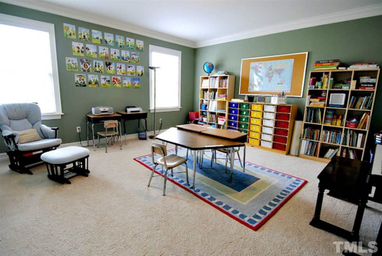 3400 Harden Road Raleigh, NC 27607 - Photo 17 of 25 a living room with furniture a bookshelf and a window