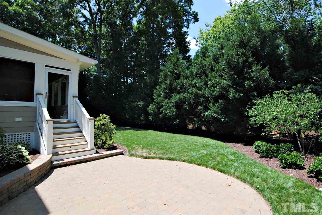 3400 Harden Road Raleigh, NC 27607 - Photo 23 of 25 a view of a patio with table and chairs with wooden fence and plants