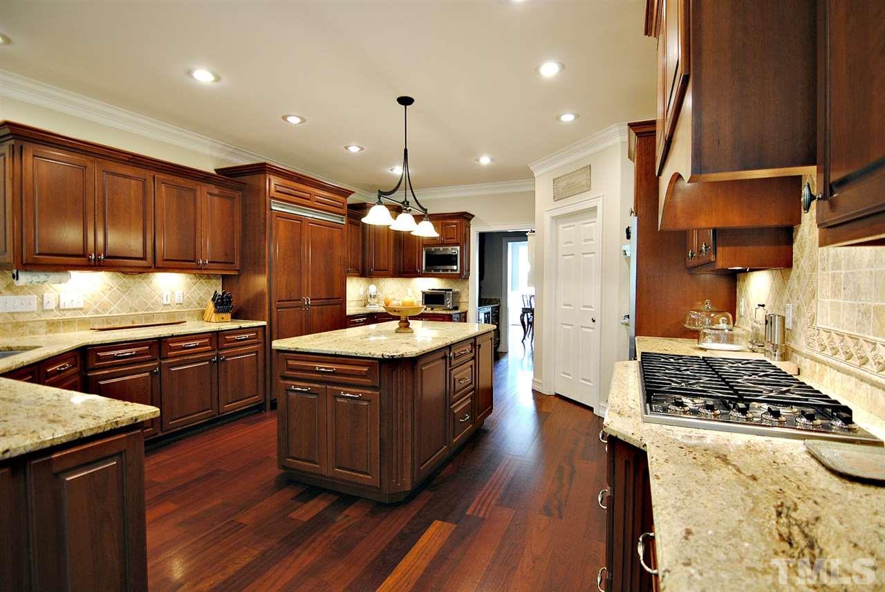3400 Harden Road Raleigh, NC 27607 - Photo 10 of 25 a kitchen with stainless steel appliances granite countertop a stove a sink dishwasher and a refrigerator with wooden floor