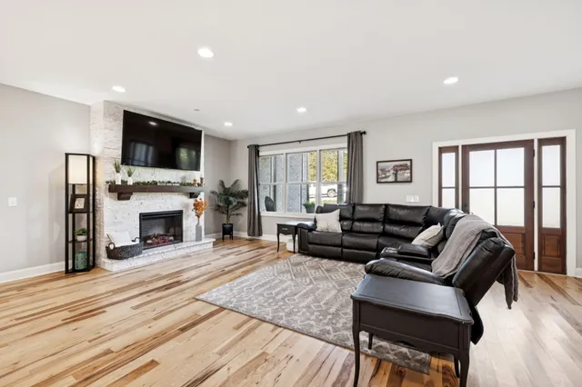 a living room with furniture and wooden floor