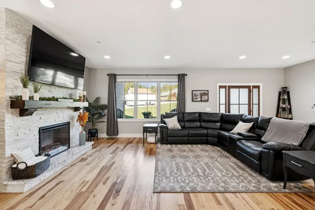 a living room with furniture and a wooden floor