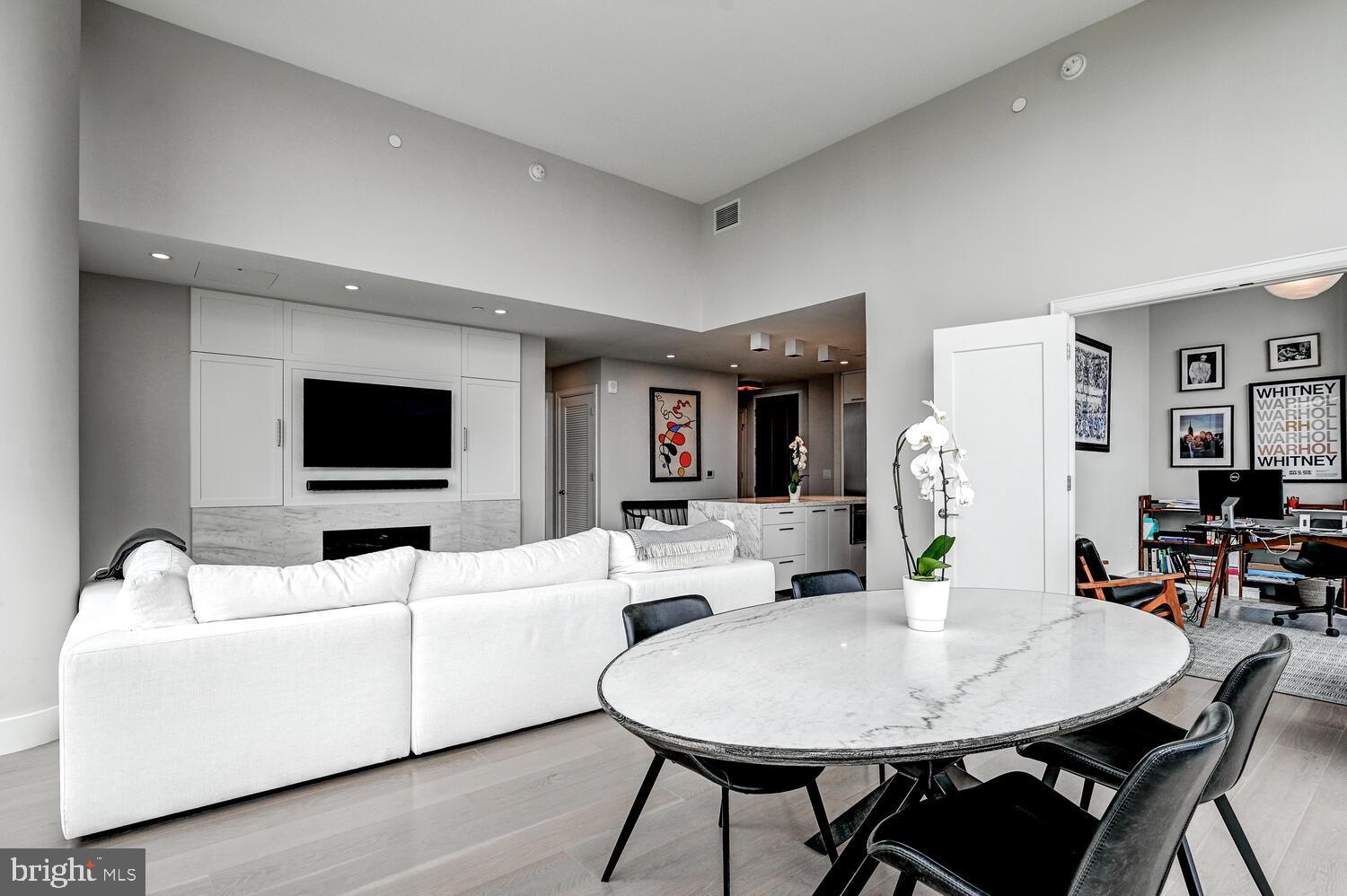 1330 Lancaster Street, Unit C901 Baltimore, MD 21231 - Photo 11 of 55 a living room with furniture a flat screen tv and a dining table