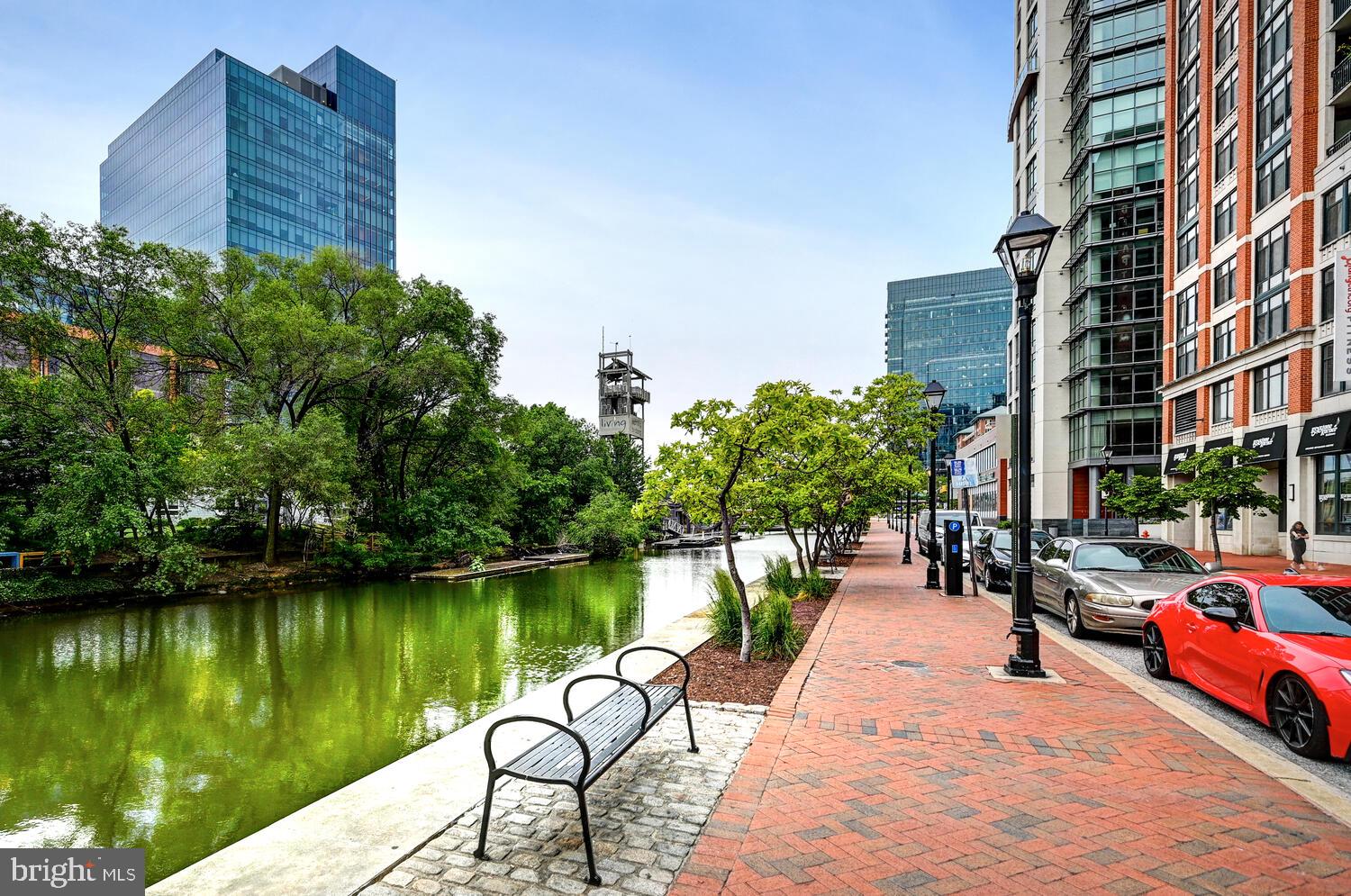 1330 Lancaster Street, Unit C901 Baltimore, MD 21231 - Photo 25 of 55 a view of a lake with a bench next to a lake