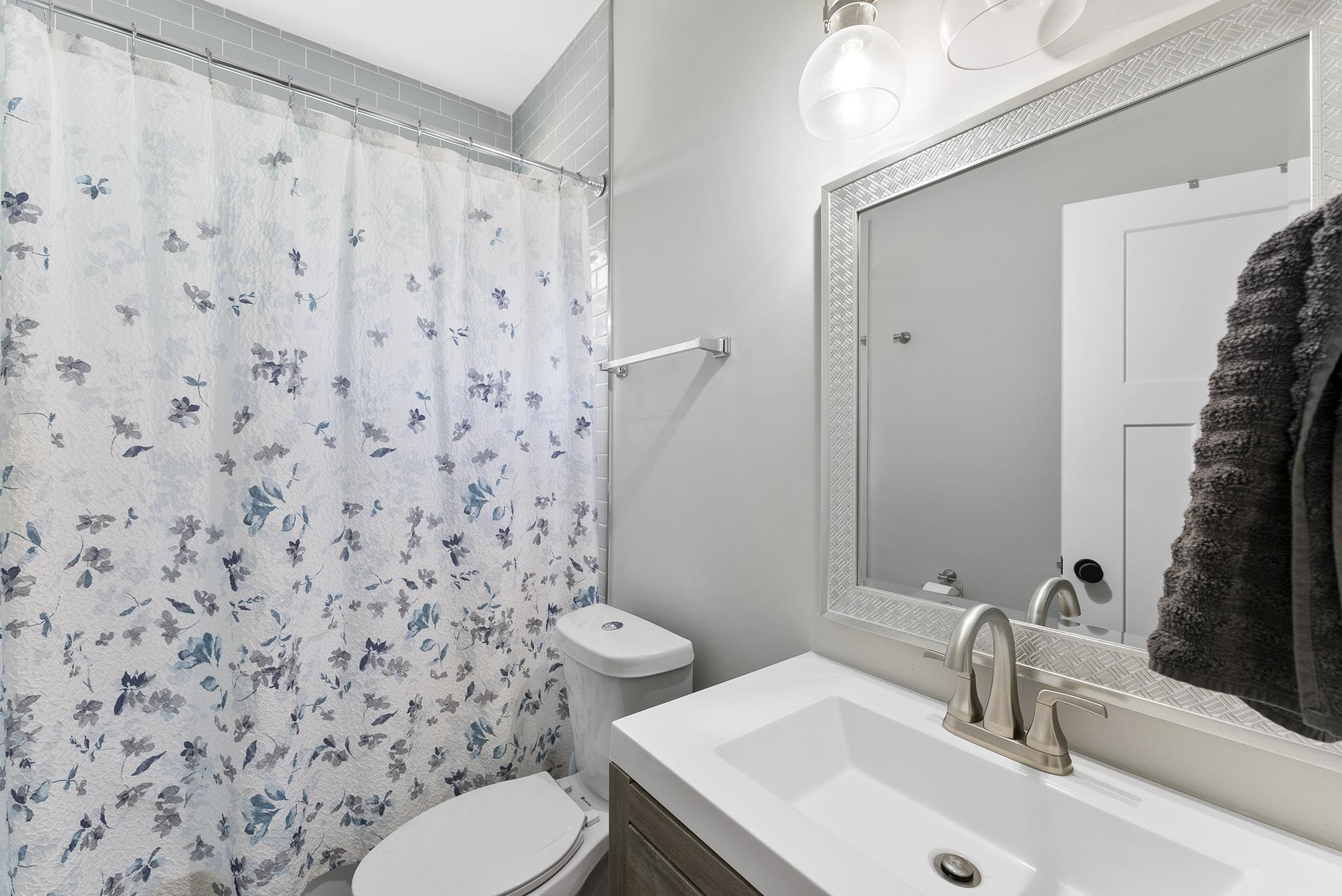 202 Lincoln Court Raleigh, NC 27610 - Photo 21 of 27 a bathroom with a sink a toilet and shower curtain