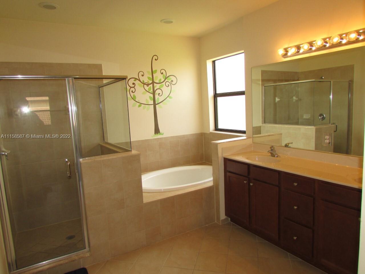 11759 Southwest 235th Street Homestead, FL 33032 - Photo 13 of 21 a bathroom with a bathtub shower sink and mirror