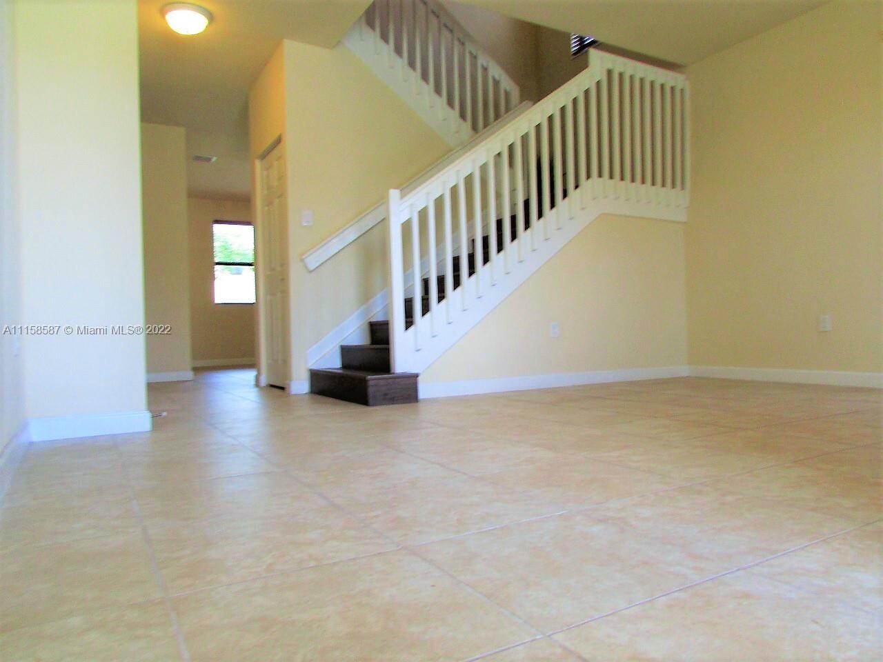 11759 Southwest 235th Street Homestead, FL 33032 - Photo 4 of 21 a view of entryway and hall with wooden floor