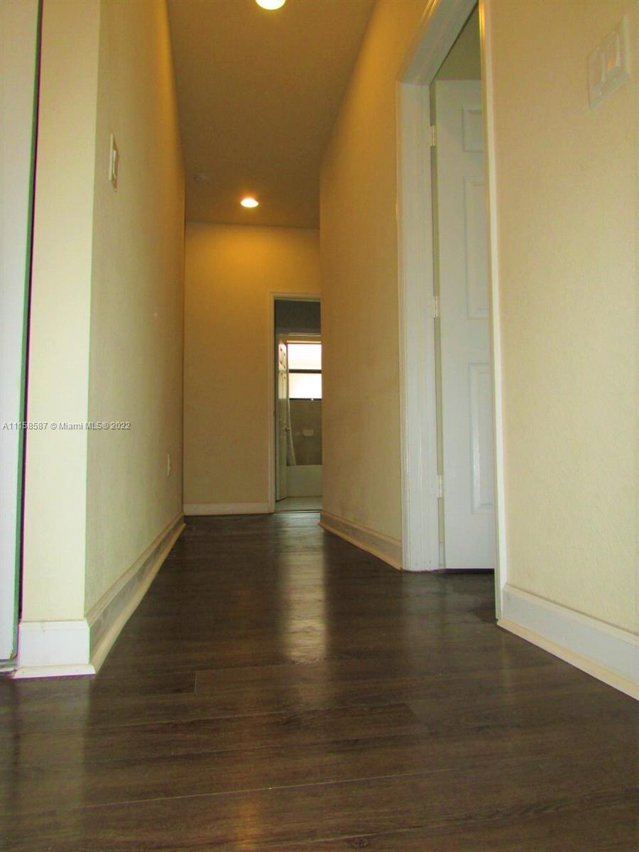 11759 Southwest 235th Street Homestead, FL 33032 - Photo 6 of 21 a view of an empty room with wooden floor and a window