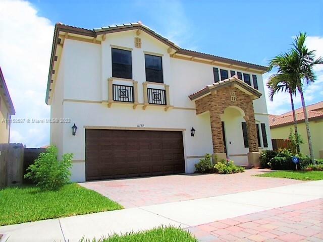 11759 Southwest 235th Street Homestead, FL 33032 - Photo 10 of 21 a front view of a house with a yard and garage