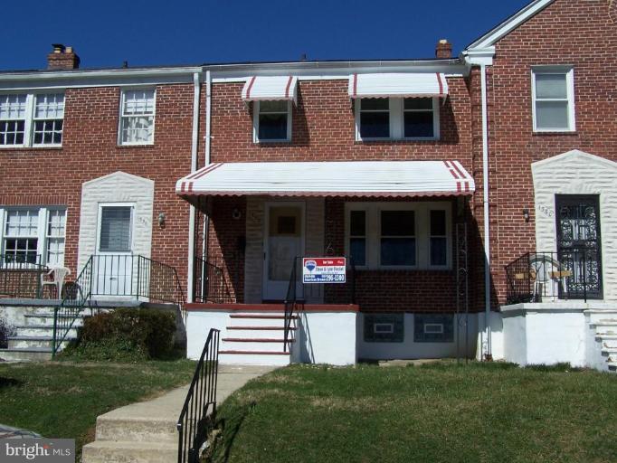 1558 Winford Road Baltimore, MD 21239 - Photo 1 of 9 a front view of a house with a yard