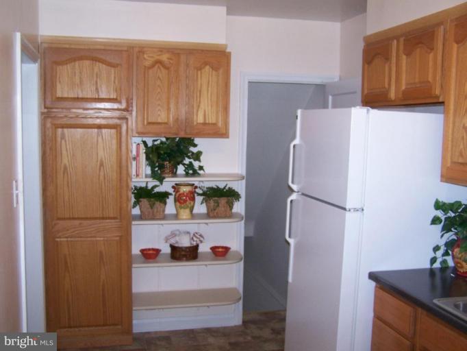 1558 Winford Road Baltimore, MD 21239 - Photo 4 of 9 a white refrigerator freezer and a wooden floor