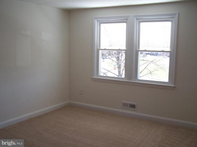 1558 Winford Road Baltimore, MD 21239 - Photo 6 of 9 an empty room with a window