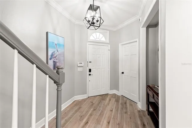 a view of entryway with hardwood floor and hallway
