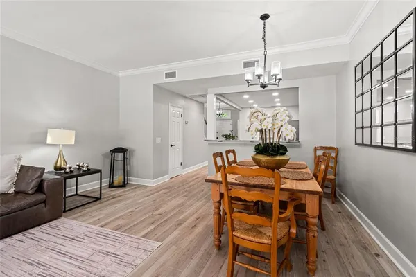 a view of a dining room with furniture window and wooden floor