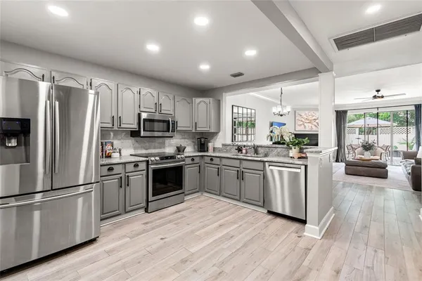 a kitchen with granite countertop stainless steel appliances and wooden cabinets