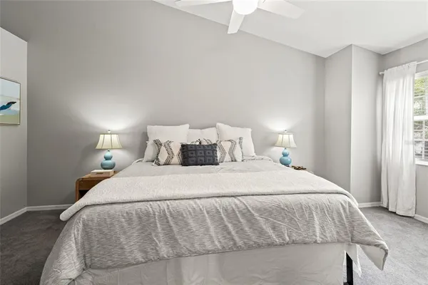 a bedroom with a bed and a night stand