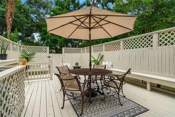 a view of a balcony with wooden floor and fence