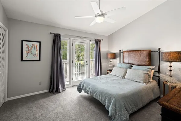 a bedroom with a large bed and a chandelier