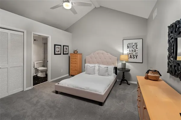 a bedroom with a bed and lamp