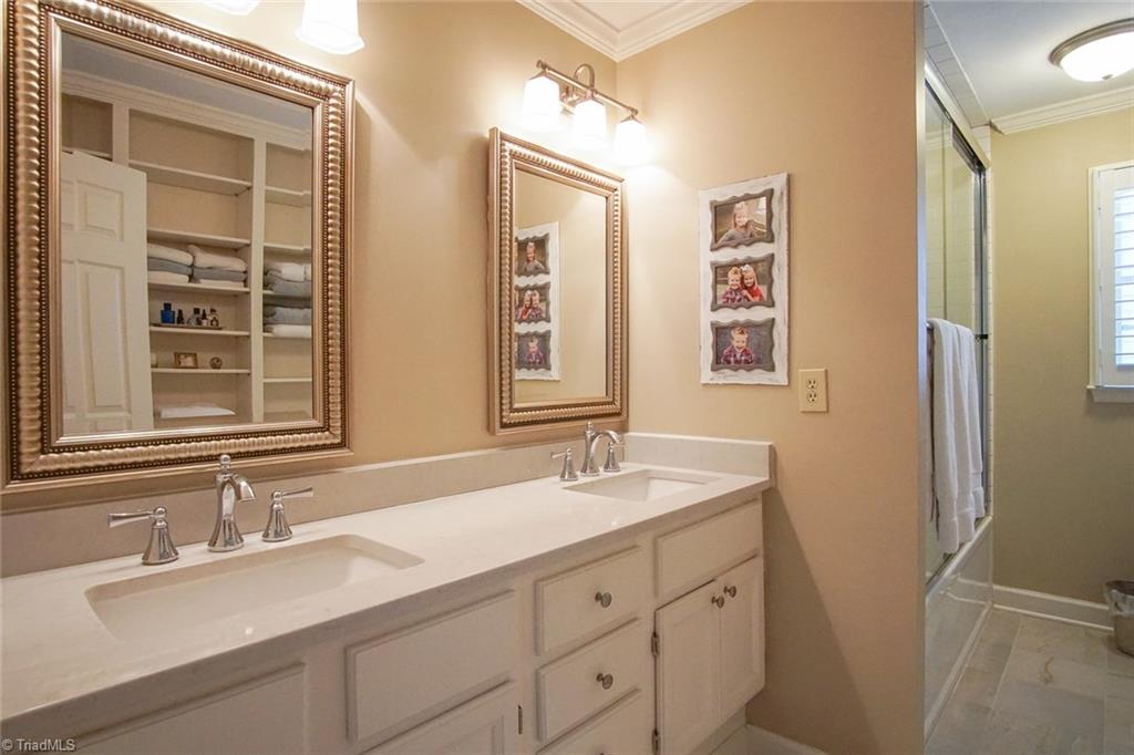 6037 Rittenhouse Road Winston-Salem, NC 27104 - Photo 19 of 30 The renovated master bath features double sinks with quartz countertops, a huge tub with subway tile surround, a rain head shower head as well as wall mounted shower head. Gorgeous!
