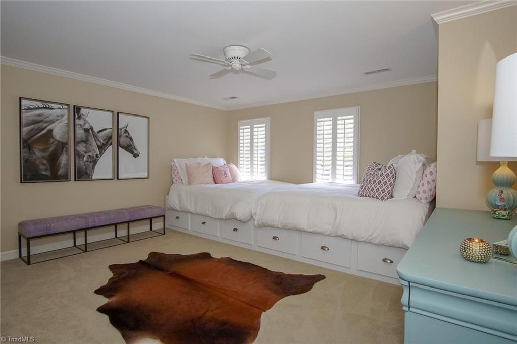 6037 Rittenhouse Road Winston-Salem, NC 27104 - Photo 20 of 30 All bedrooms in this beautiful home are oversized and feature generous closets. This second bedroom has two large, walk-in closets. These beds are not permanently attached and will be removed for buyers.