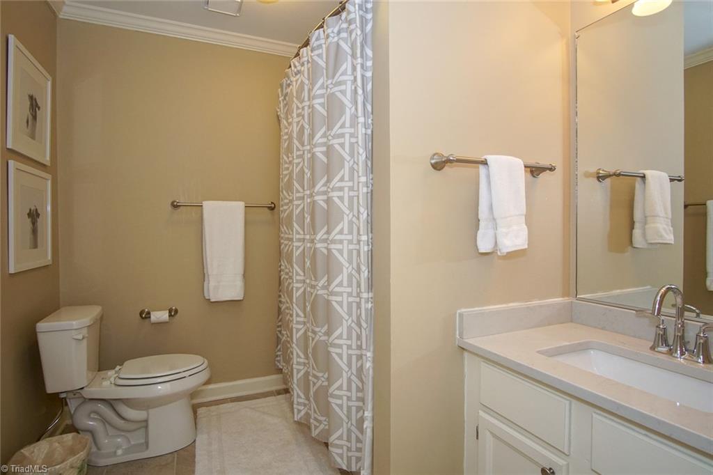 6037 Rittenhouse Road Winston-Salem, NC 27104 - Photo 21 of 30 Completely renovated second (hall) bath. New tub and subway tile surround, quartz sink countertop, high end fixtures.