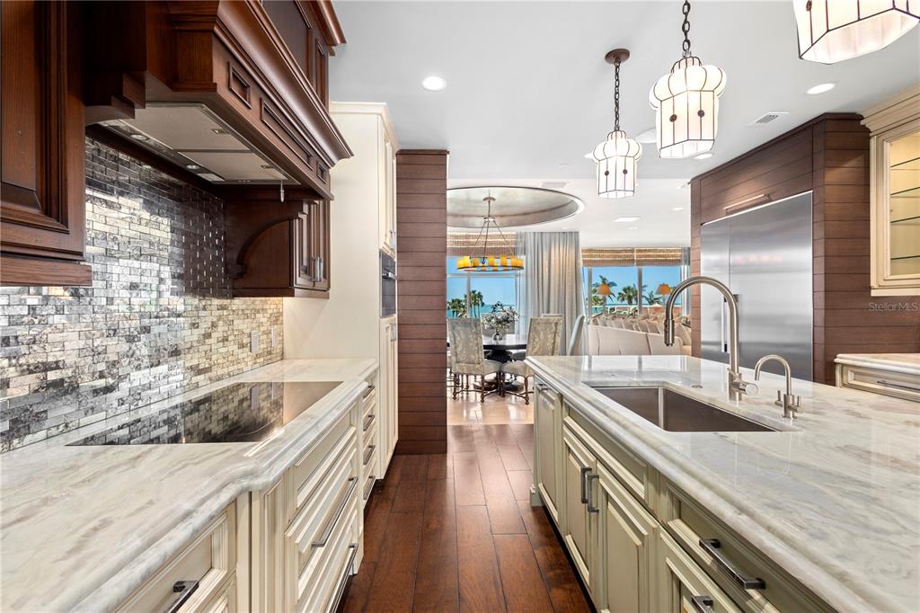 2251 Gulf Of Mexico Drive, Unit 203 Longboat Key, FL 34228 - Photo 11 of 21 a kitchen with granite countertop a sink a counter top space stainless steel appliances and cabinets