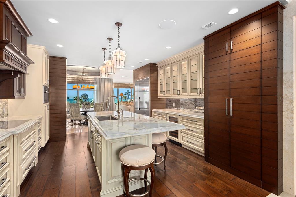 2251 Gulf Of Mexico Drive, Unit 203 Longboat Key, FL 34228 - Photo 12 of 21 a kitchen with stainless steel appliances granite countertop a stove a refrigerator and wooden floor