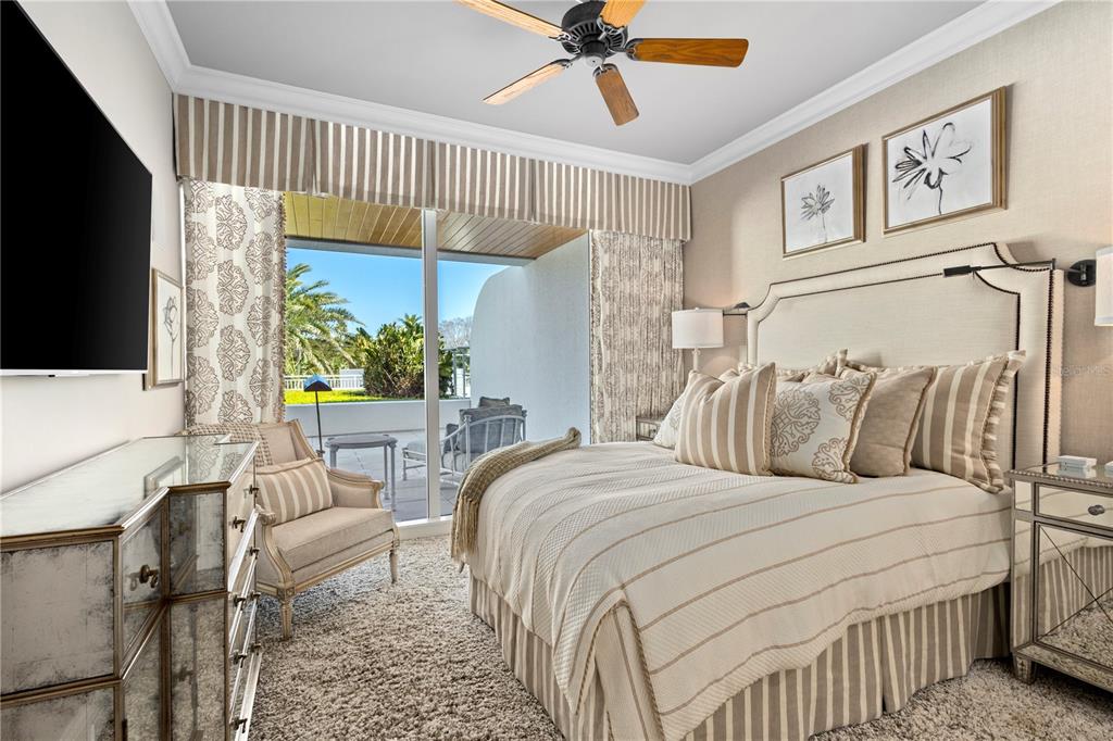 2251 Gulf Of Mexico Drive, Unit 203 Longboat Key, FL 34228 - Photo 15 of 21 a bedroom with a bed a couch and a window