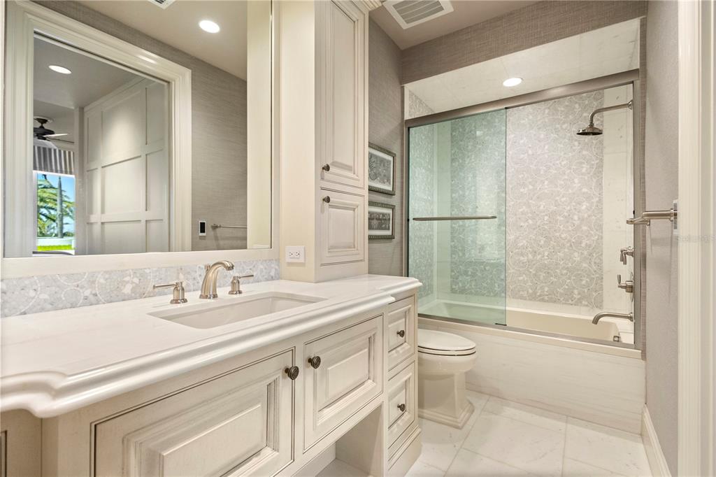 2251 Gulf Of Mexico Drive, Unit 203 Longboat Key, FL 34228 - Photo 16 of 21 a bathroom with a sink a toilet and shower