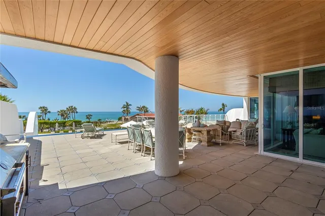 a view of a building with a yard and sitting area