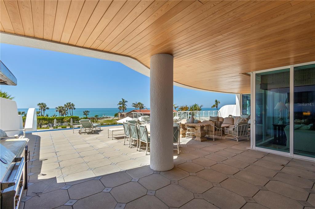 2251 Gulf Of Mexico Drive, Unit 203 Longboat Key, FL 34228 - Photo 19 of 21 a view of a patio with dining table and chairs