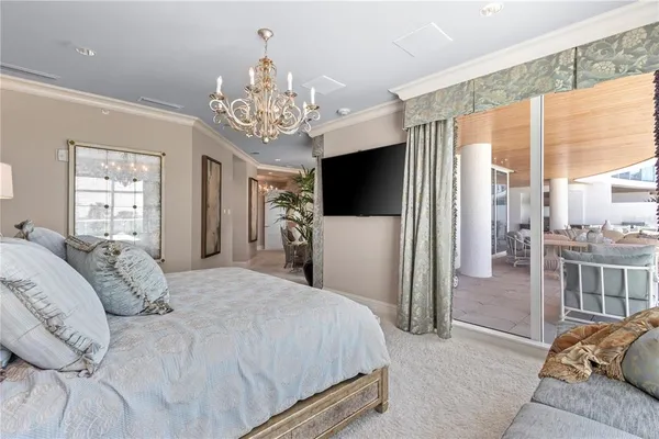 a spacious bedroom with a bed and a television