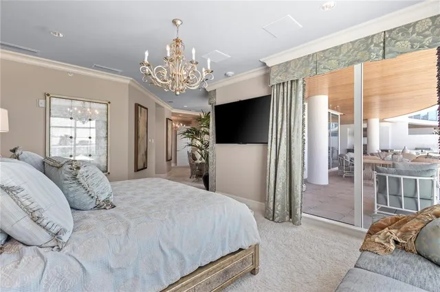 a spacious bedroom with a bed and a television