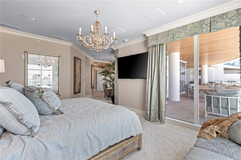 2251 Gulf Of Mexico Drive, Unit 203 Longboat Key, FL 34228 - Photo 3 of 21 a spacious bedroom with a bed and a television