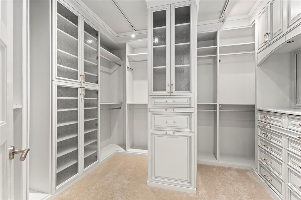 2251 Gulf Of Mexico Drive, Unit 203 Longboat Key, FL 34228 - Photo 4 of 21 a view of walk in closet with empty racks