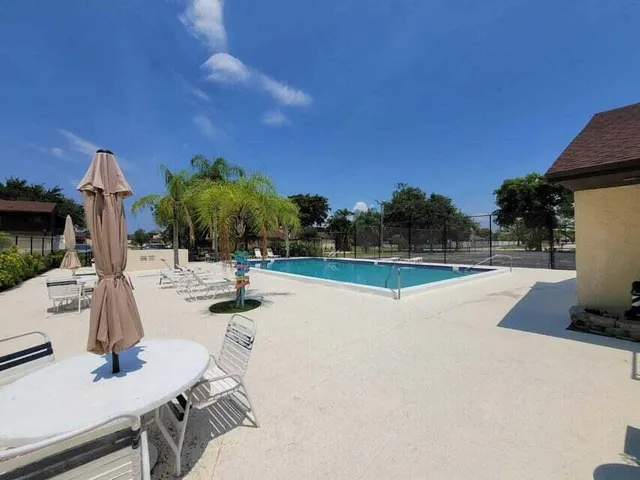 a view of a swimming pool with a patio