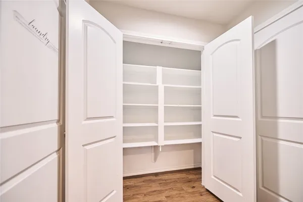 a view of walk in closet with empty racks