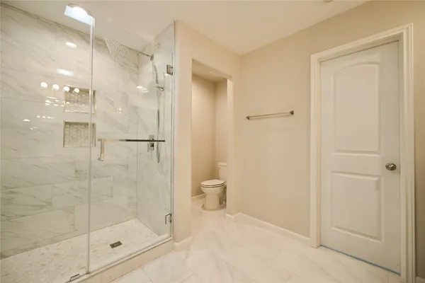 a bathroom with a shower and a glass door