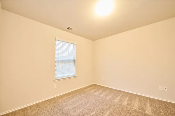 a view of empty room with windows