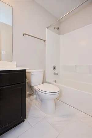 a bathroom with a toilet a sink and a bathtub