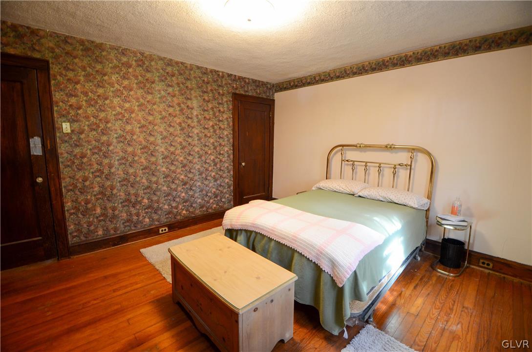 152 Sterling Road Mount Pocono, PA 18344 - Photo 14 of 36 a bedroom with a bed and wooden floor