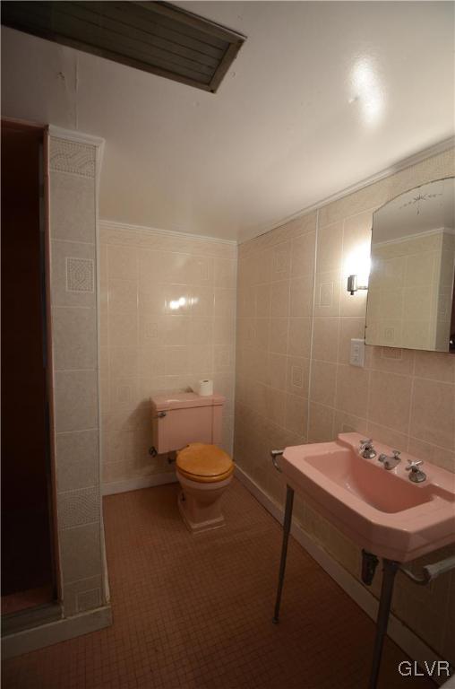 152 Sterling Road Mount Pocono, PA 18344 - Photo 26 of 36 a bathroom with a sink a toilet and a mirror