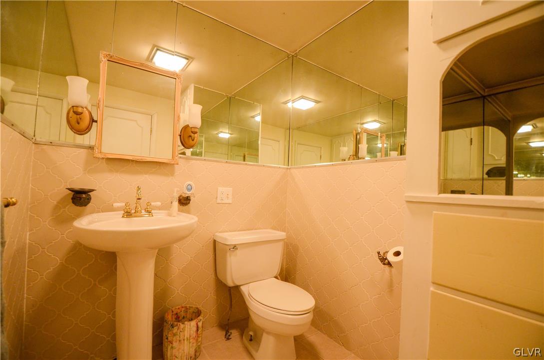 152 Sterling Road Mount Pocono, PA 18344 - Photo 4 of 36 a bathroom with a sink and mirror with toilet