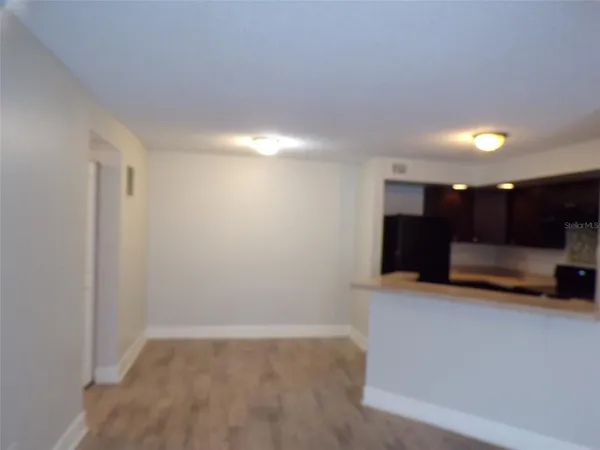a view of kitchen with a sink and a refrigerator