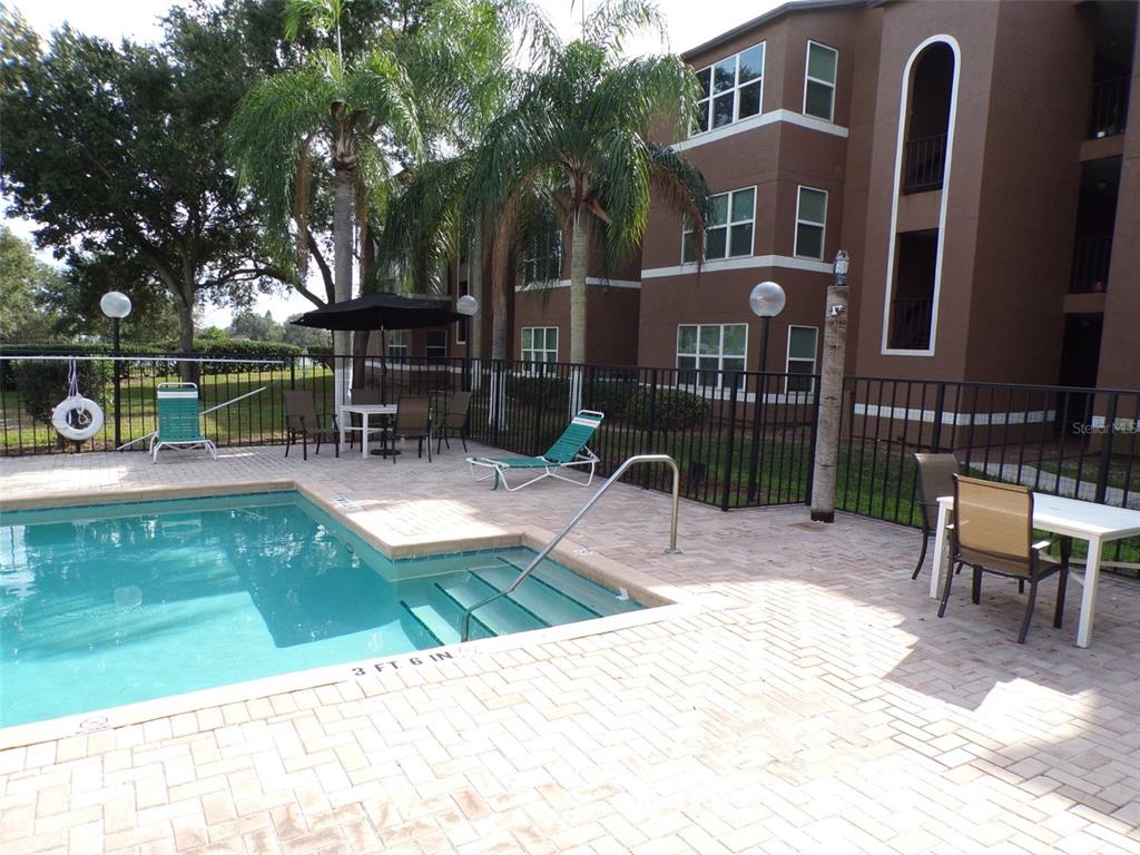 4518 Commander Drive, Unit 1921 Orlando, FL 32822 - Photo 2 of 18 swimming pool view with a outdoor seating