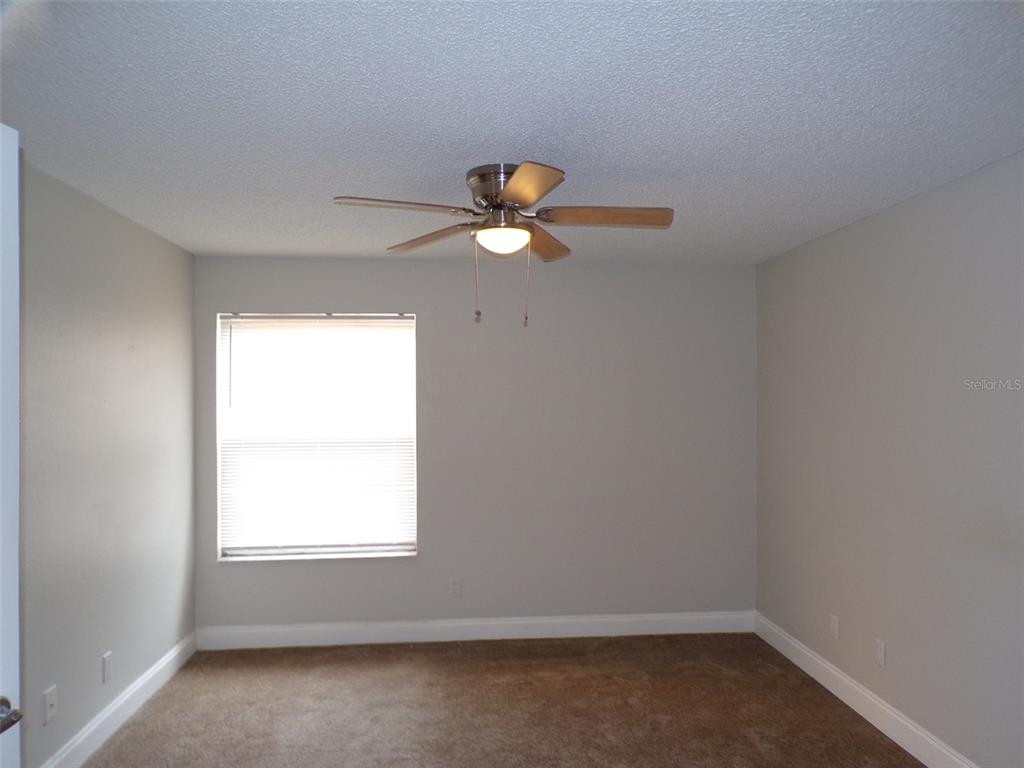 4518 Commander Drive, Unit 1921 Orlando, FL 32822 - Photo 6 of 18 an empty room with a window