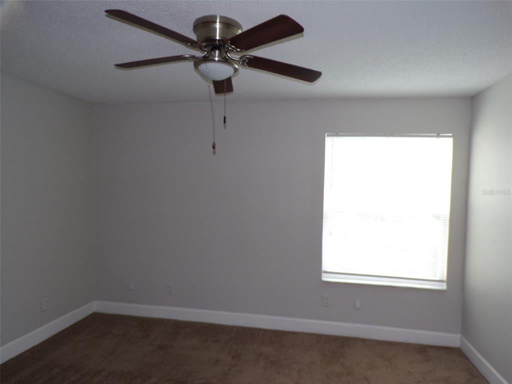 4518 Commander Drive, Unit 1921 Orlando, FL 32822 - Photo 8 of 18 an empty room with a window