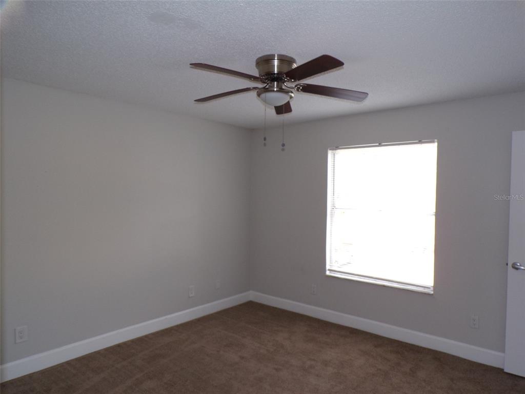 4518 Commander Drive, Unit 1921 Orlando, FL 32822 - Photo 10 of 18 an empty room with a window and a fan